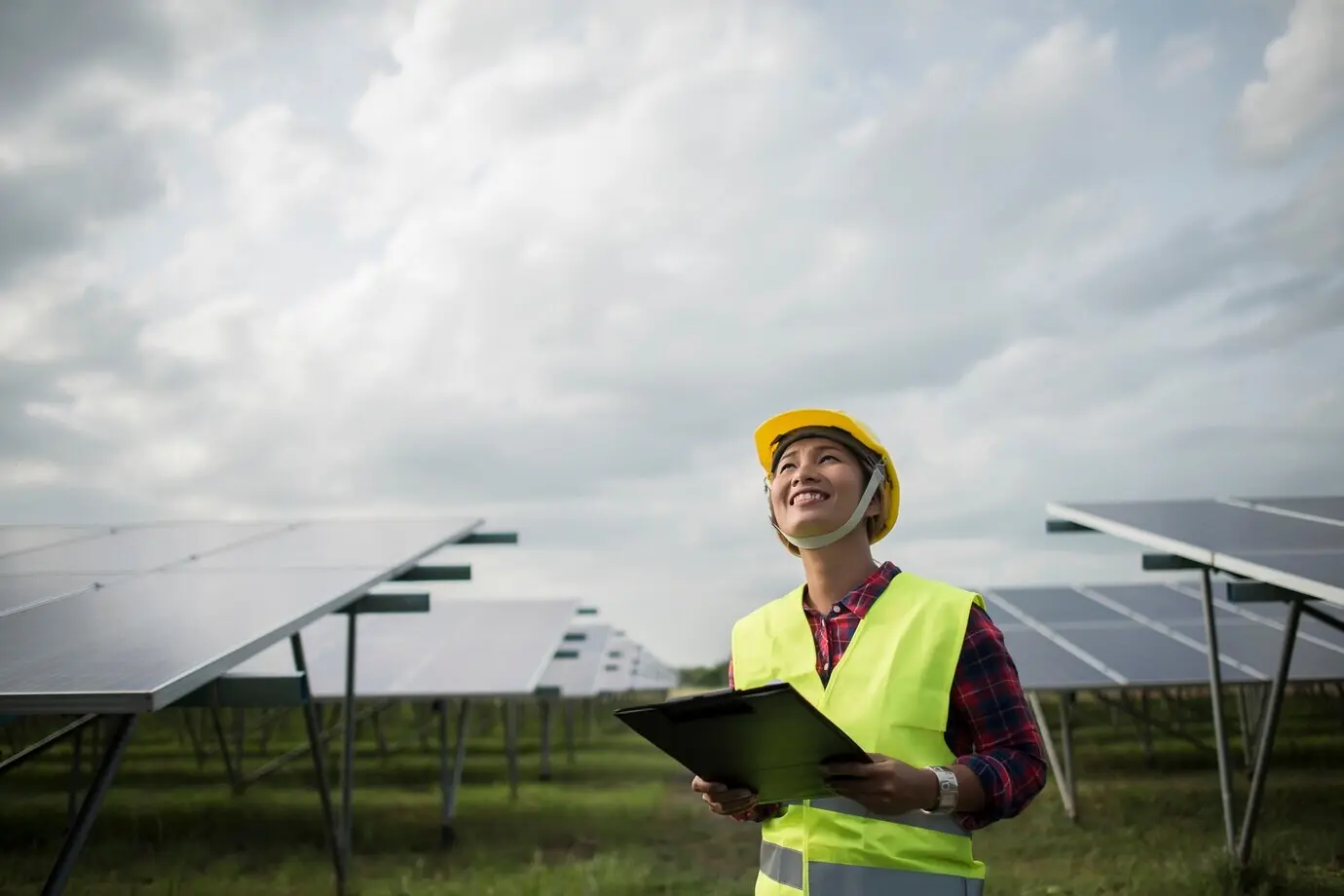 A female electrical engineer inspecting and maintaining solar cells.