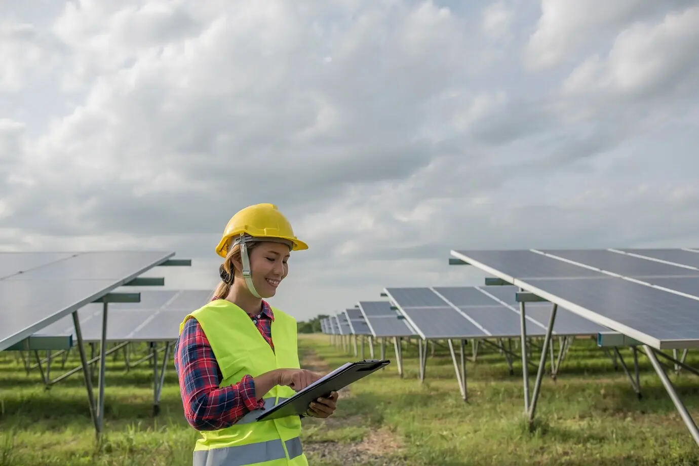 A female electrical engineer inspecting and maintaining solar cells.