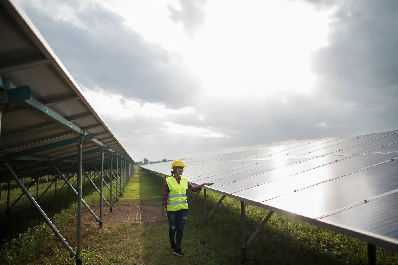 Female electrical engineer inspecting and maintaining solar cells.